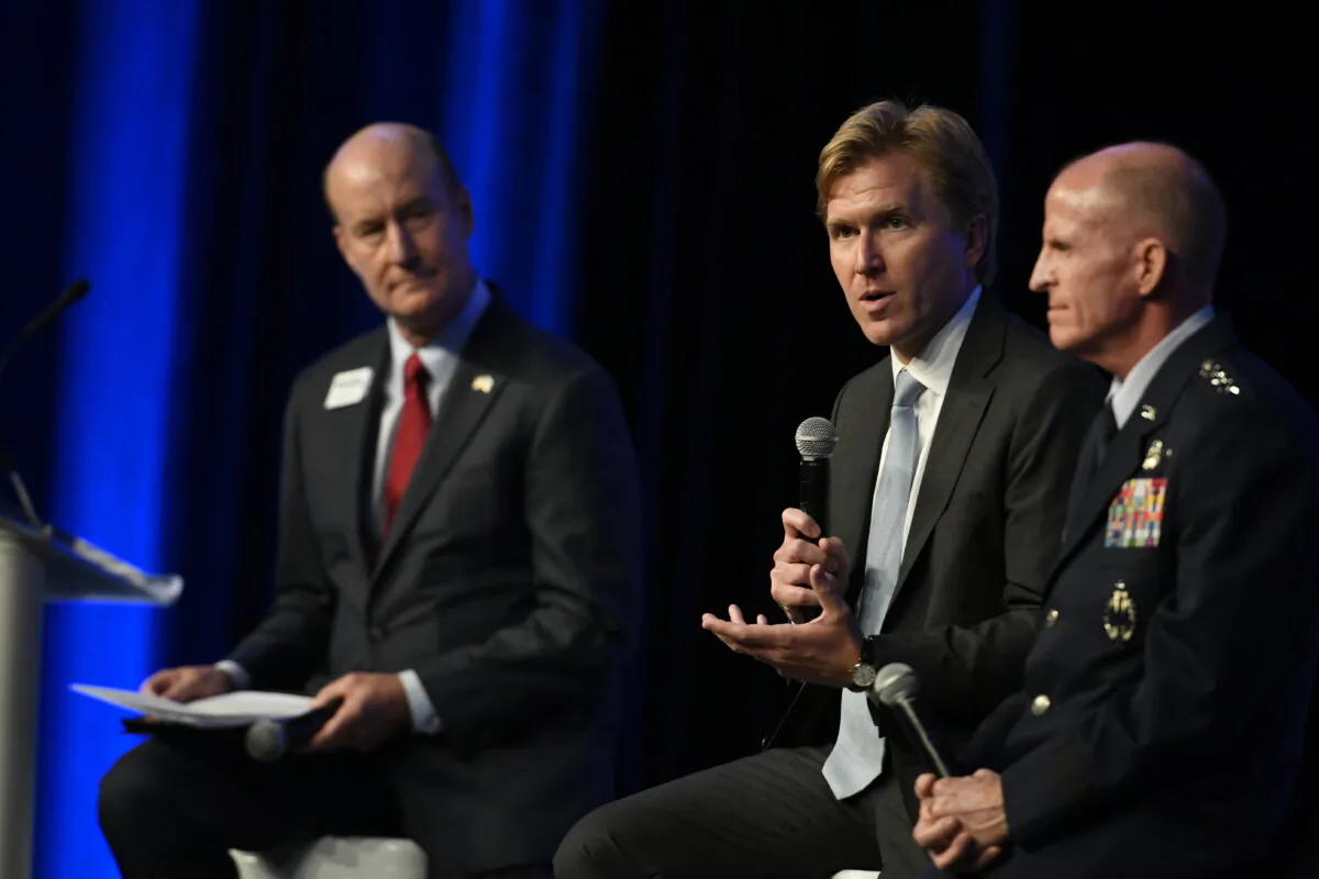 Gen. Stephen W. Wilson (R) and Elbridge Colby (C) participate in a panel discussion at the Air Force Association's Air, Space and Cyber Conference in National Harbor, Md., Sept. 17, 2019. (U.S. Air Force photo by Staff Sgt. Chad Trujillo)