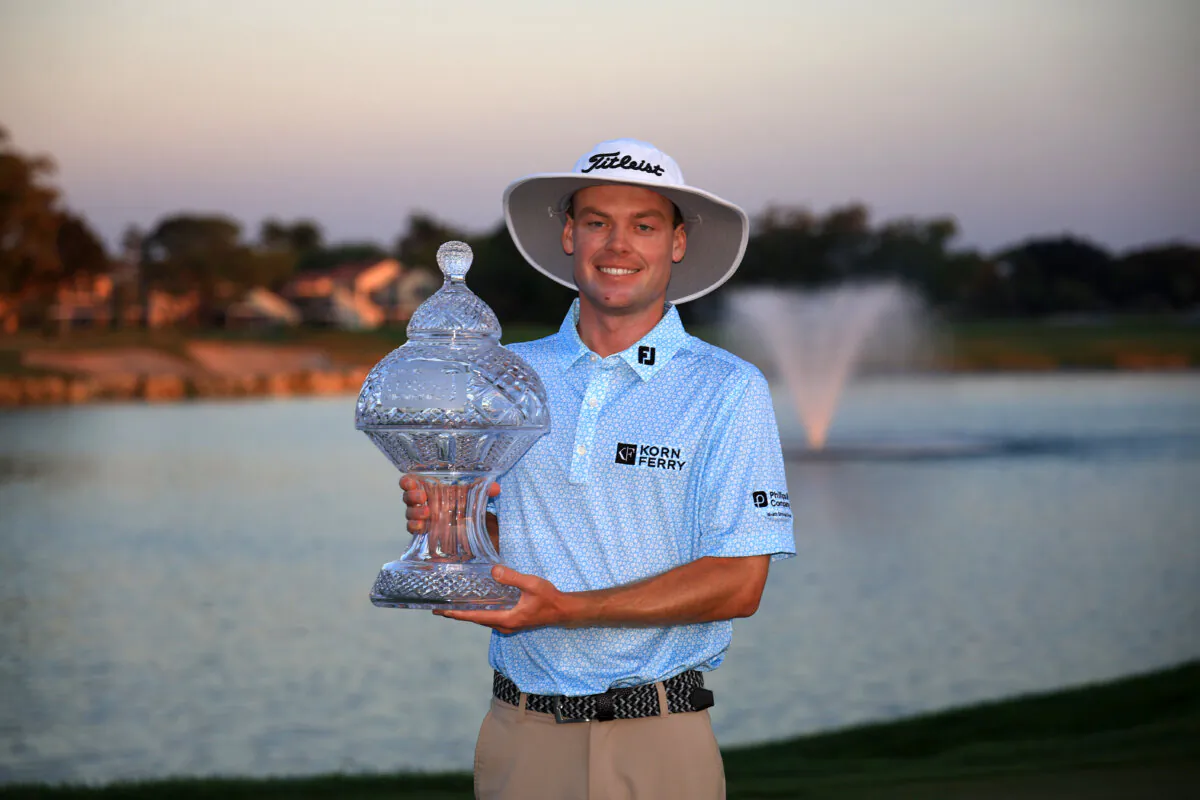 Joe Highsmith of the United States poses with the trophy after putting in to win on the 18th green during the final round of the Cognizant Classic in The Palm Beaches 2025 at PGA National Resort And Spa in Palm Beach Gardens, Fla., on March 2, 2025. (Mike Ehrmann/Getty Images)