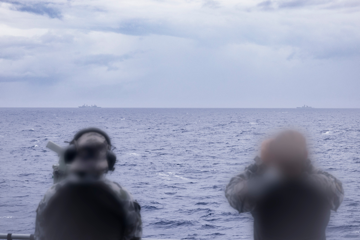 Royal Australian Navy sailors on HMAS Arunta keeping watch on People's Liberation Army-Navy (PLA-N) Fuchi-class replenishment vessel Weishanhu and Jiangkai-class frigate Hengyang in the Tasman Sea.