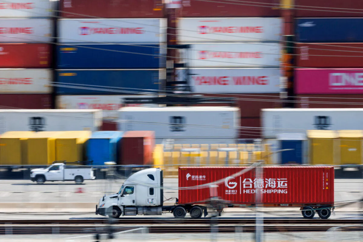 Vehicles drive past shipping containers from China at the China Shipping (North America) Holding Company Ltd. facility at the Port of Los Angeles in Wilmington, Calif., on Feb. 4, 2025. (Mike Blake/Reuters)