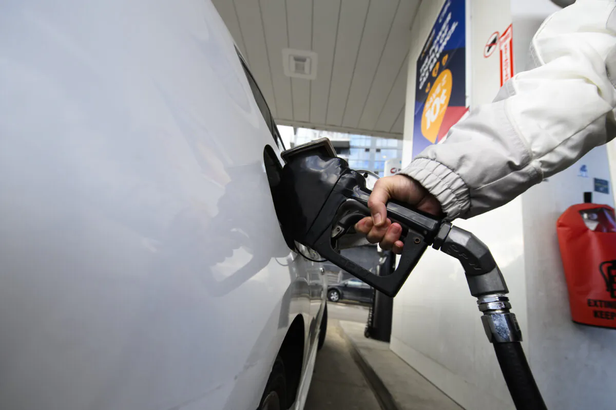A person pumps gas into their vehicle at a gas station in Mississauga, Ont., on Feb. 13, 2024. (The Canadian Press/Christopher Katsarov) 