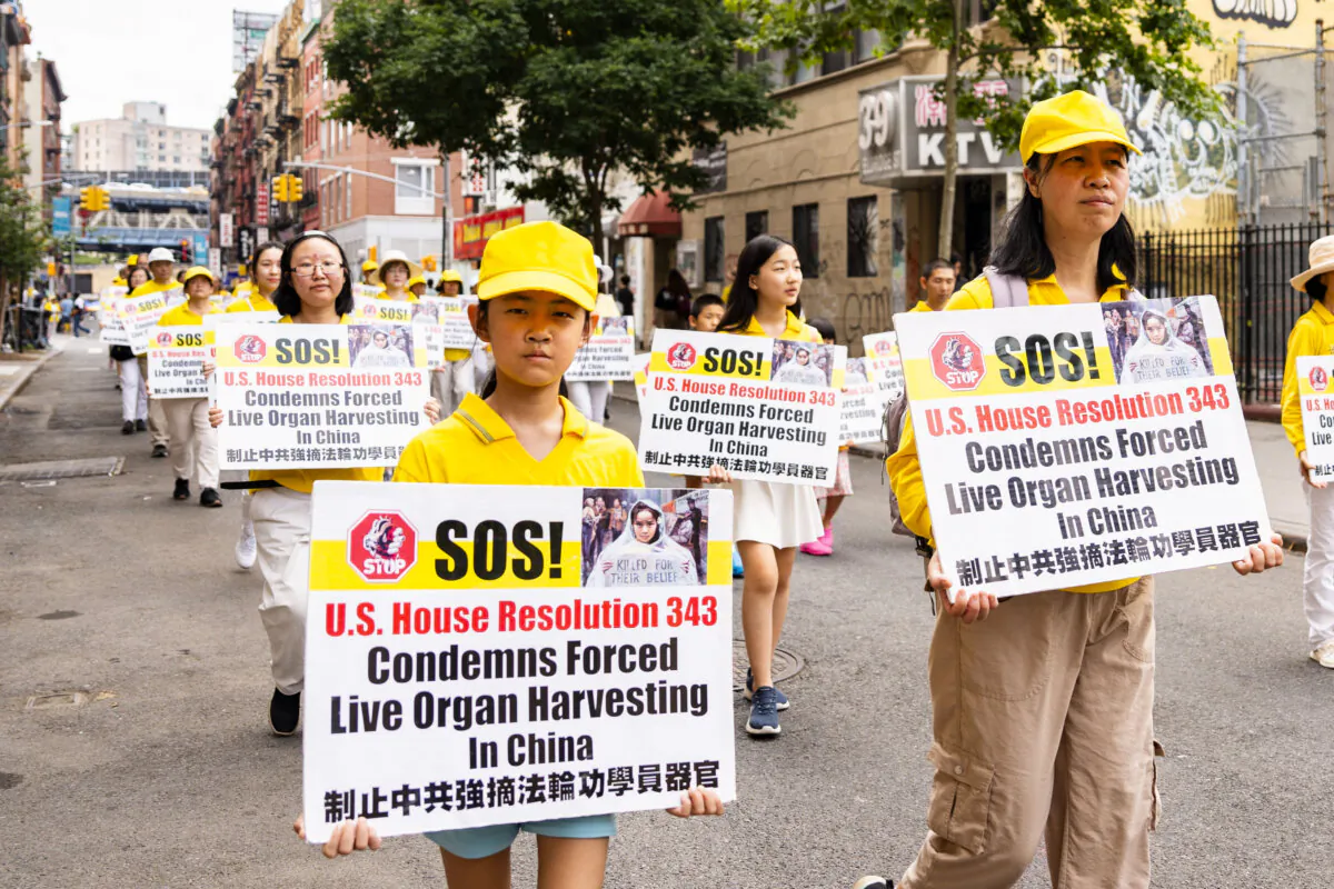 Falun Gong practitioners march during a parade calling for the end of the Chinese Communist Party's 25 years of ongoing persecution against the spiritual practice, in New York City on July 20, 2024.(Samira Bouaou/The Epoch Times)