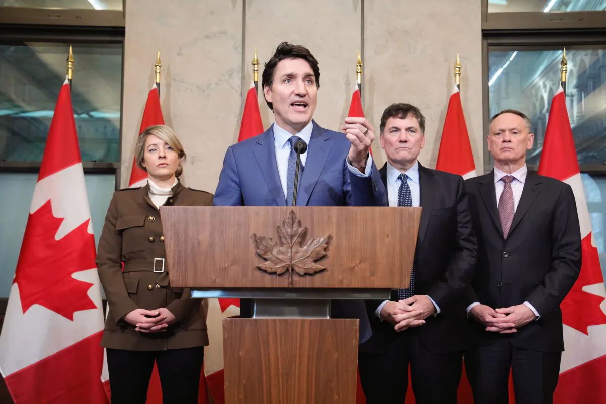 Prime Minister Justin Trudeau holds a news conference on imposed U.S. tariffs as Foreign Affairs Minister Melanie Joly, Finance Minister Dominic LeBlanc and Public Safety Minister David McGuinty look on in Ottawa on March 4, 2025. (Adrian Wyld/The Canadian Press)