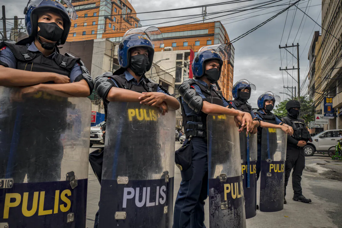 Riot police officers stand guard during a protest in Manila, Philippines, on May 21, 2022. (Ezra Acayan/Getty Images)