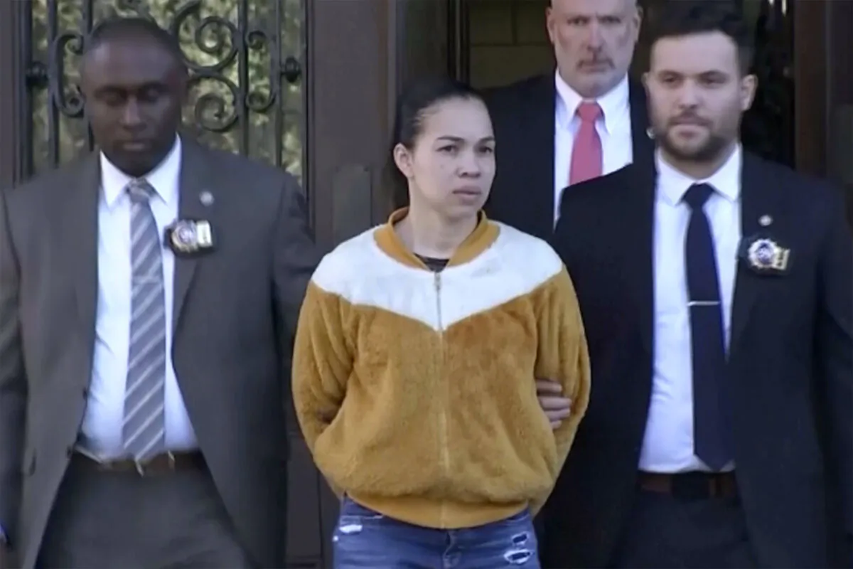 Grei Mendez (C) is escorted by law enforcement personnel from a New York Police station in New York on Sept. 19, 2023, in a still from video. (WABC-TV via AP)