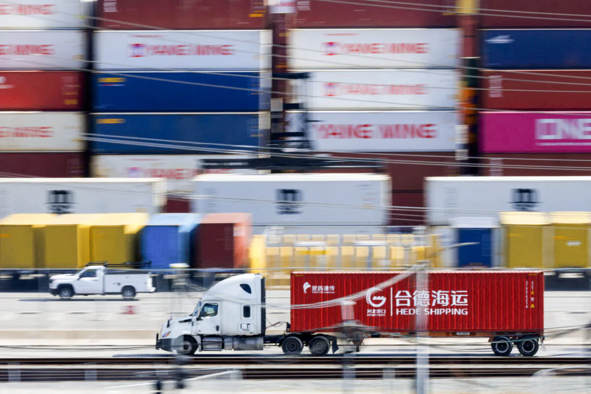 Vehicles drive past shipping containers from China at the China Shipping (North America) Holding Company Ltd. facility at the Port of Los Angeles in Wilmington, Calif., on Feb. 4, 2025. (Mike Blake/Reuters)