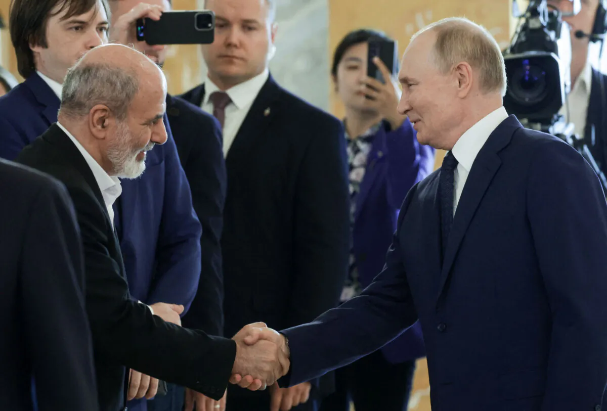 Russia's President Vladimir Putin shakes hands with Ali Akbar Ahmadian, secretary of Iran's Supreme National Security Council, in Saint Petersburg on Sept. 12, 2024. (Vyacheslav Prokofyev/AFP via Getty Images)