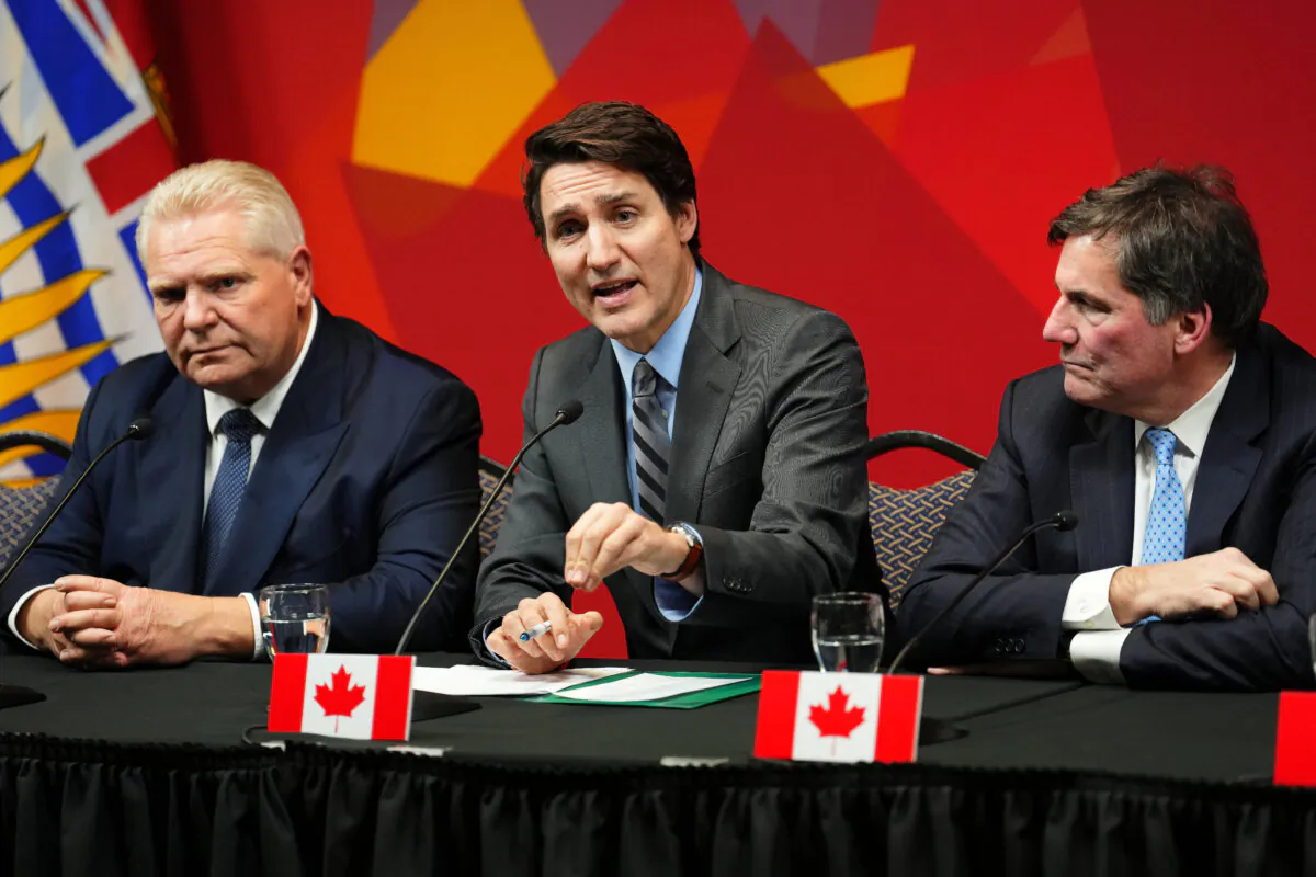 Ontario Premier Doug Ford (L), and Intergovernmental Affairs Minister Dominic Leblanc look on as Prime Minister Justin Trudeau speaks at a press conference concluding a first ministers meeting, in Ottawa, on Jan. 15, 2025. (The Canadian Press/Sean Kilpatrick)