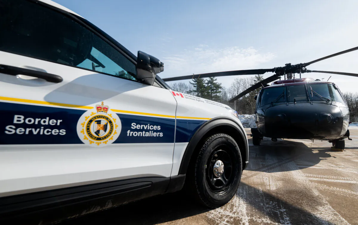 A Canada Border Services Agency cruiser is parked next to a RCMP Sikorsky UH-60 Black Hawk at the CBSA Lansdowne port of entry in Lansdowne, Ont., on Feb. 12, 2025. (The Canadian Press/Spencer Colby) 