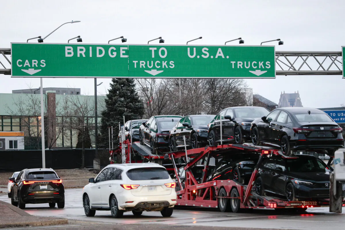 A car hauler heads across the Ambassador Bridge between Windsor, Canada, and Detroit on the first day of President Donald Trump's new 25 percent tariffs on goods from Canada and Mexico on March 4, 2025. (Bill Pugliano/Getty Images)