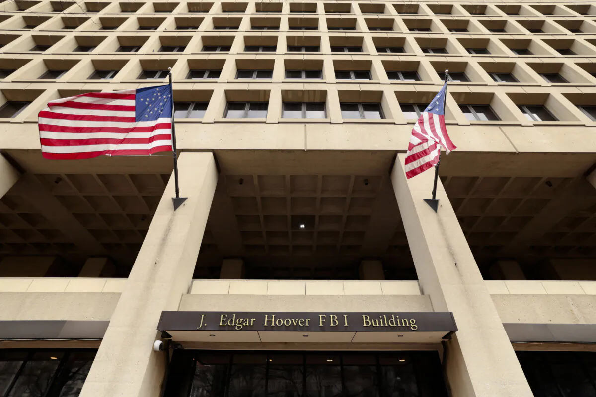 Flags fly over an entrance to FBI headquarters in Washington on Feb. 3, 2025. (Kevin Lamarque/Reuters)
