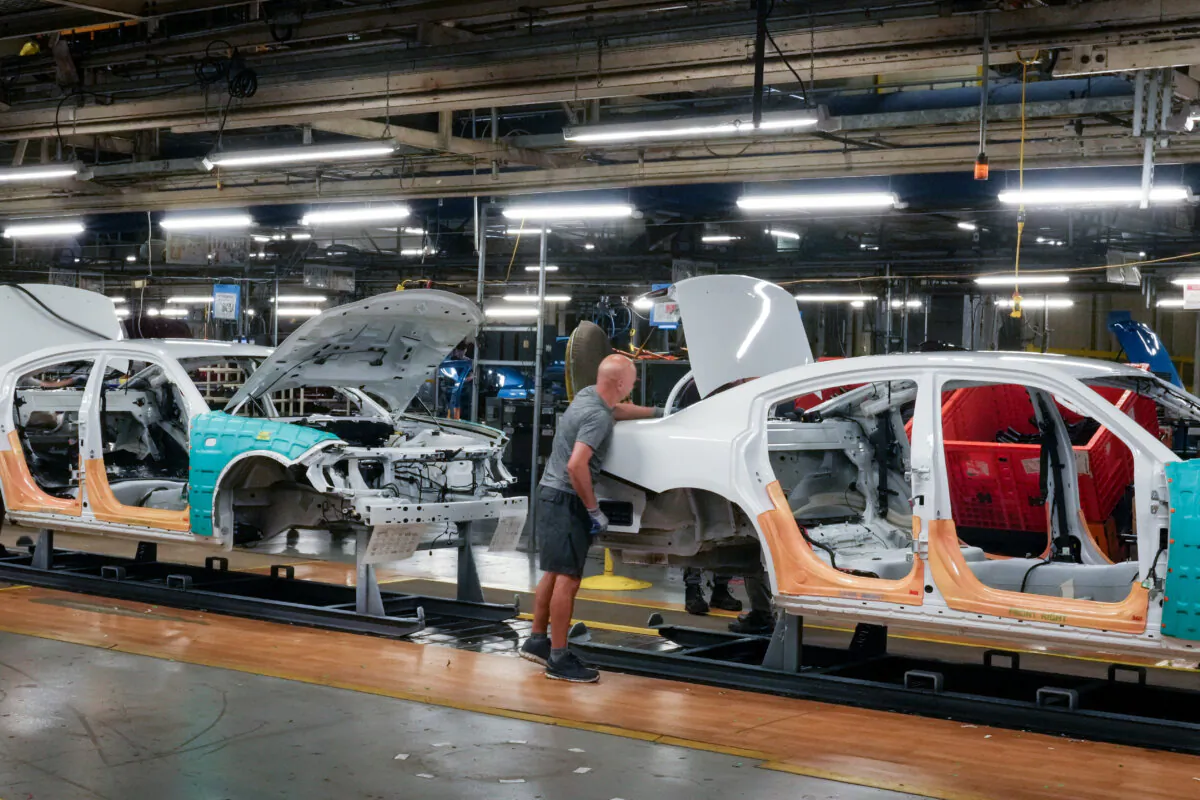Cars pass along the assembly line at the Stellantis plant in Brampton, Ont., on July 21, 2023. (The Canadian Press/Chris Young) 