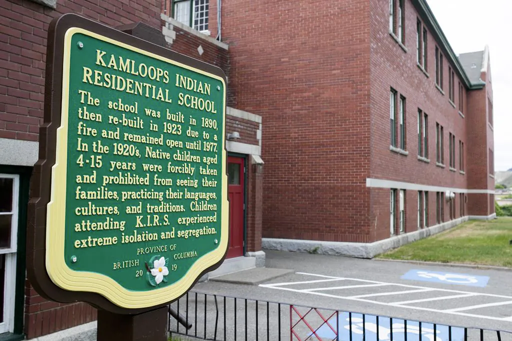 A plaque is seen outside the former Kamloops Indian Residential School on the Tk’emlúps te Secwépemc First Nation in Kamloops, B.C., on May 27, 2021. (The Canadian Press/Andrew Snucins)