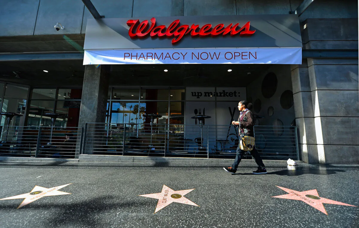 A woman walks past a Walgreens at the corner of Sunset and Vine in the Hollywood neighborhood of Los Angeles on Jan. 15, 2013. Kevork Djansezian/Getty Images