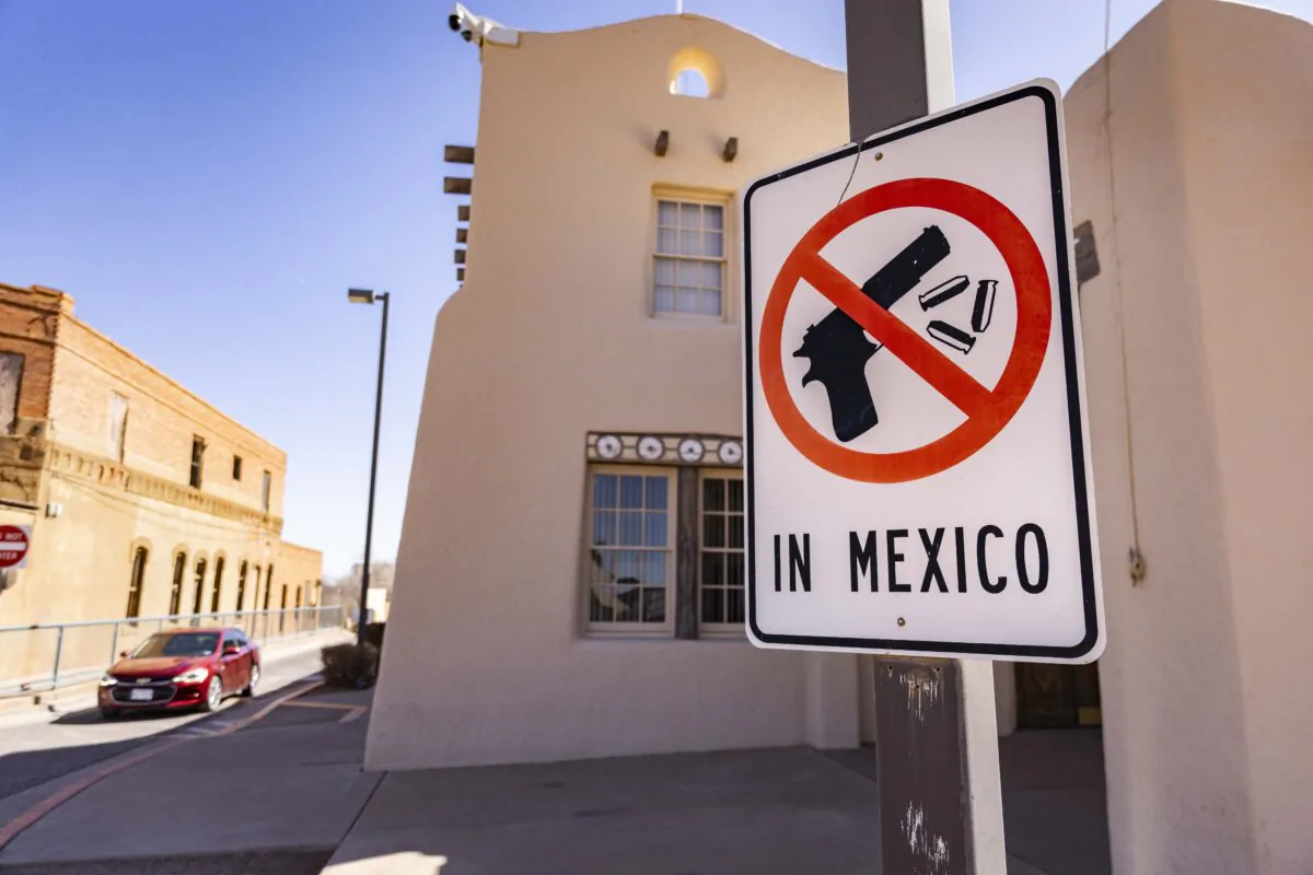 A sign displaying "No firearms in Mexico" is outside a border entry point in Naco, Ariz., on March 5, 2025. (John Fredricks/The Epoch Times)