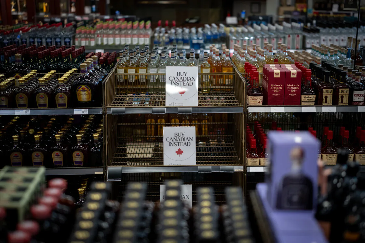 A sign is placed in front of the American whiskey section at a B.C. Liquor Store after top selling American made products have been removed from shelves in Vancouver, Feb. 2, 2025. (THE CANADIAN PRESS/Ethan Cairns)