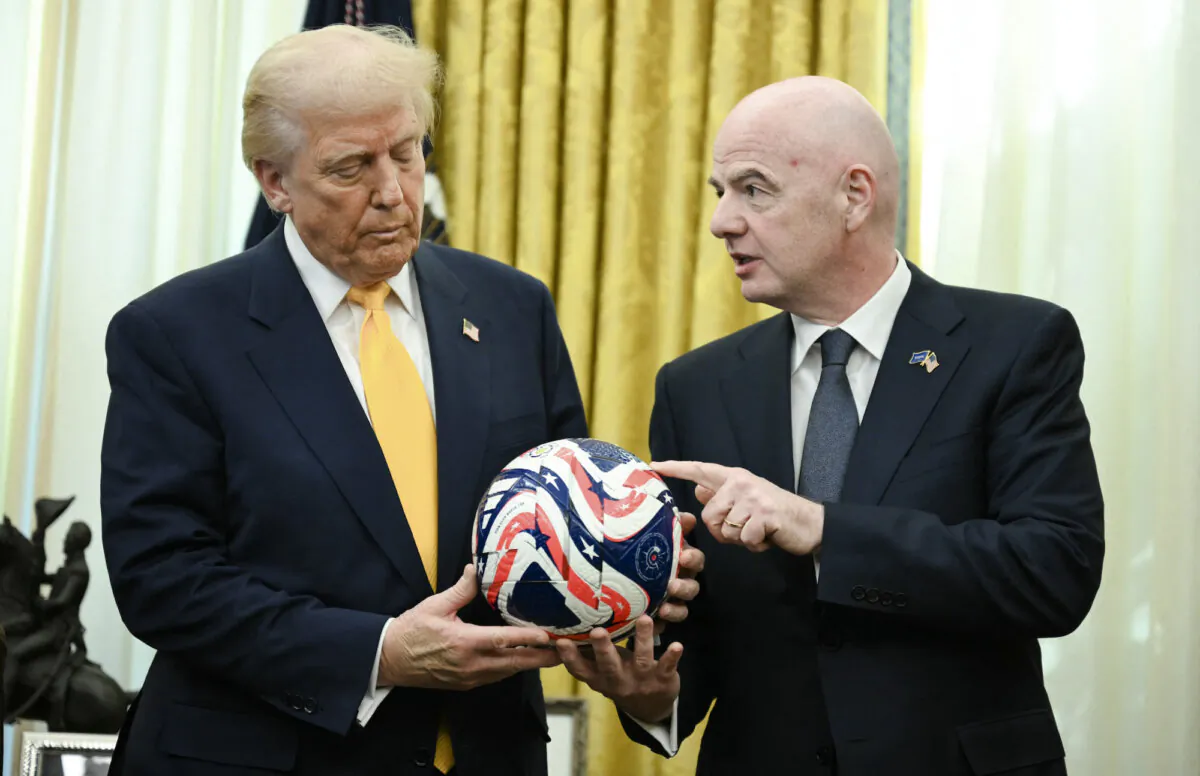President Donald Trump (L) is presented with the new FIFA Club World Cup official ball by FIFA president Gianni Infantino, in the Oval Office of the White House, in Washington, on March 7, 2025. (Jim Watson/AFP/Getty Images)