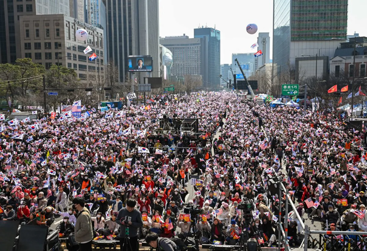Supporters of arrested and impeached South Korean President Yoon Suk Yeol wave South Korean and the U.S. flags during a rally in downtown Seoul on March 8, 2025. (Jung Yeon-je/AFP via Getty Images)