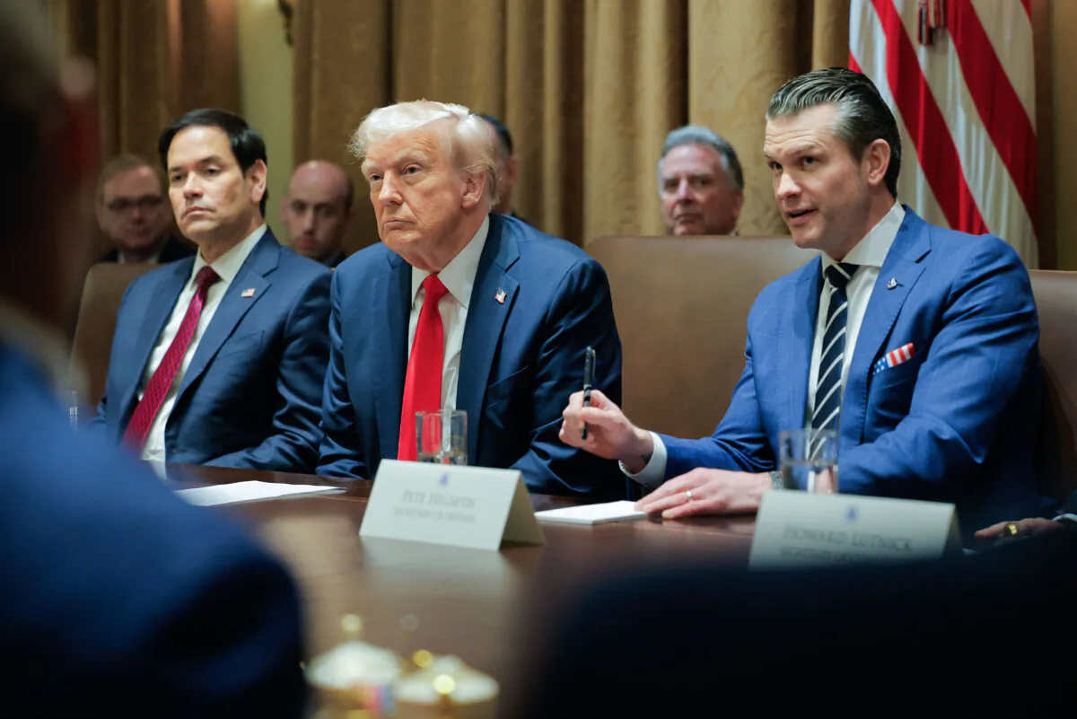 President Donald Trump listens during a Cabinet meeting at the White House on Feb. 26, 2025, as Secretary of State Marco Rubio (L) and Defense Secretary Pete Hegseth (R) listen. (Pool via AP)