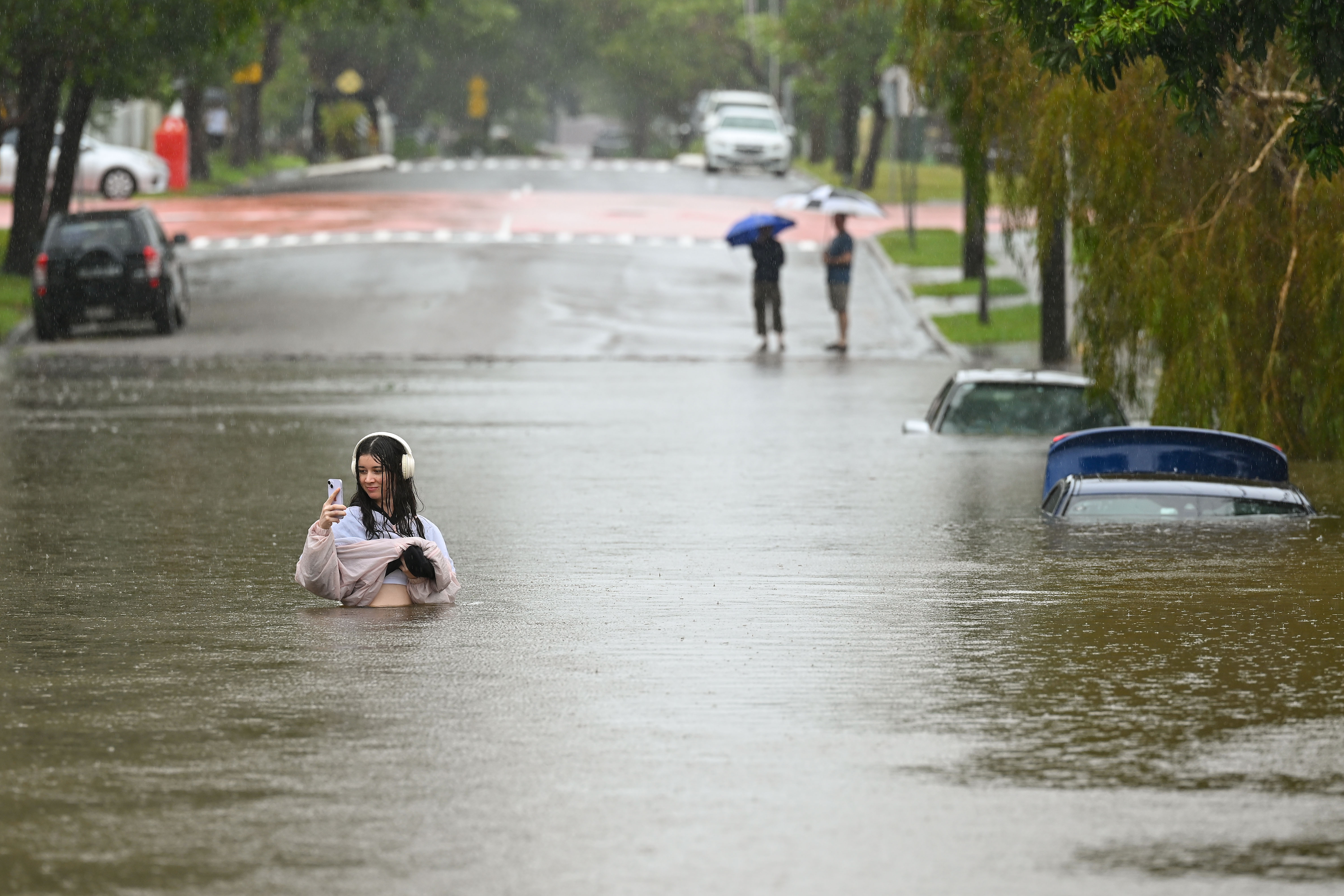 Day in Photos: Flooding in Australia, Confrontation Outside White House, Rally in Syria