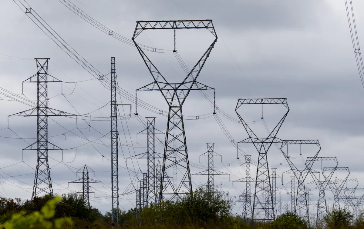 Power lines are seen against cloudy skies near Murvale, Ont., northwest of Kingston, on Sept. 7, 2022. (The Canadian Press/Adrian Wyld)