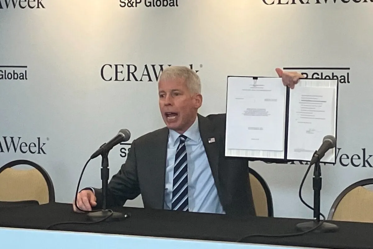 U.S. Energy Secretary Chris Wright displays the order he just signed approving Delfin LNG LLC’s permit through June 2029 to begin exporting LNG from its offshore Louisiana terminal, in Houston on March 11, 2025. (John Haughey/The Epoch Times)