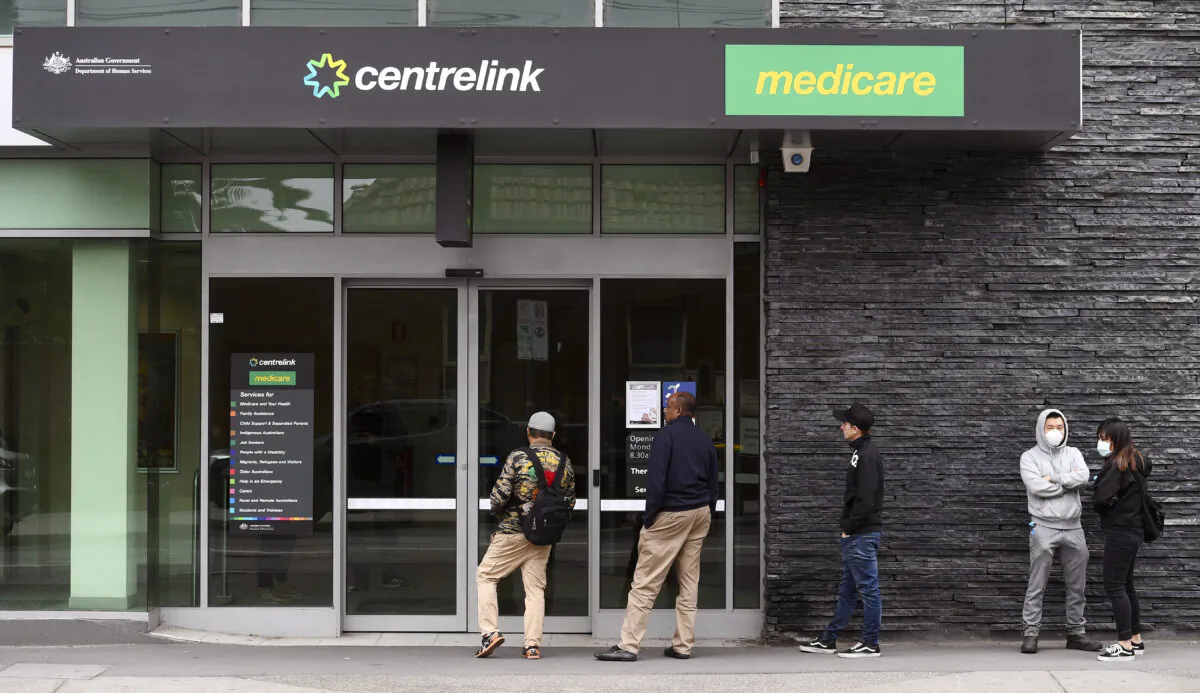 People queue outside an Australian government welfare centre, Centrelink, in Melbourne, Australia, on March 23, 2020. (William West/AFP via Getty Images)