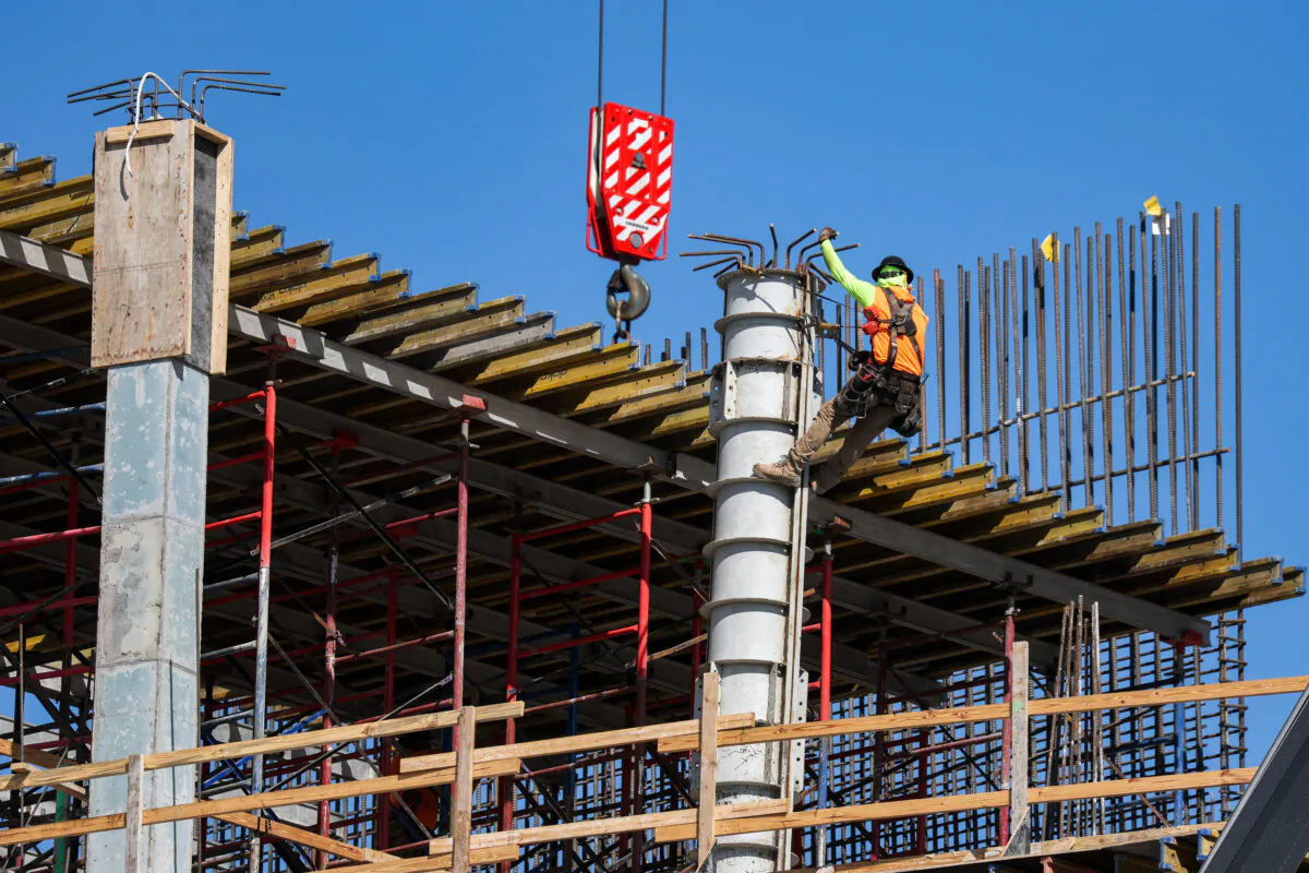 A construction worker helps build a support column using steel rebar during the building of a condo tower in Miami, Fla., on Feb. 10, 2025. (Joe Raedle/Getty Images)