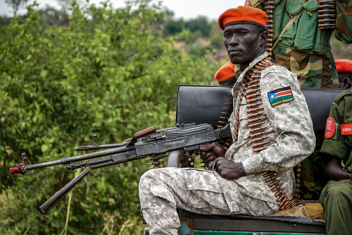 A South Sudanese military police officer sits on a pickup truck while monitoring the area as troops belonging to the South Sudanese Unified Forces take part in a deployment ceremony at the Luri Military Training Centre in Juba, on Nov. 15, 2023. (Peter Louis Gume/AFP via Getty Images)