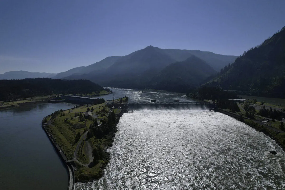 Water spills over the Bonneville Dam on the Columbia River, which runs along the Washington and Oregon state line, on June 21, 2022. (The Canadian Press/AP-Jessie Wardarski)