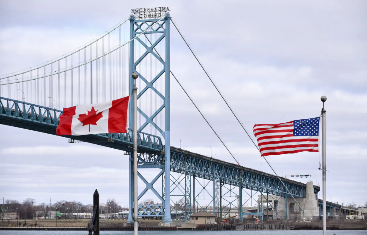 Canadian and American flags fly near Ambassador Bridge at the Canada-U.S. border crossing in Windsor, Ont., in a file photo. (The Canadian Press/Rob Gurdebeke)