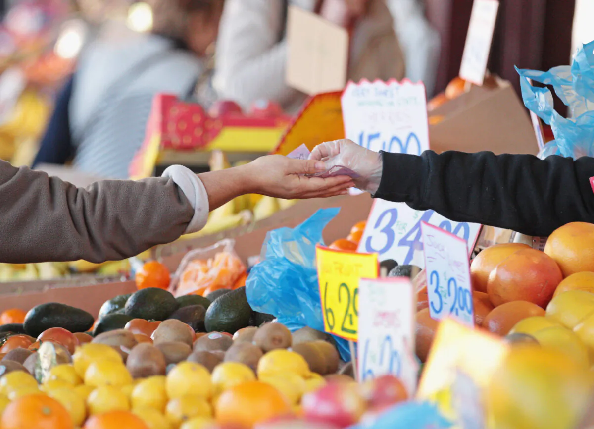 A woman pays for her purchases at the Queen Victoria Market in Melbourne, Australia, on July 11, 2014. (Scott Barbour/Getty Images)