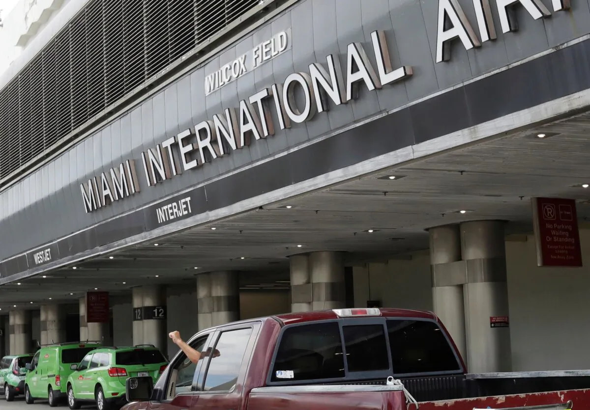Vehicles drive past the entrance to Miami International Airport in Miami on May 12, 2020. (Wilfredo Lee/AP Photo)