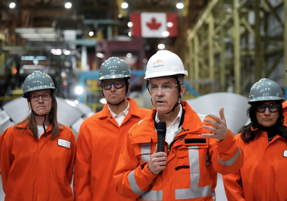 Canadian Prime Minister designate Mark Carney, second right, speaks to steel workers after touring the ArcelorMittal Dofasco steel plant in Hamilton, Ont., on March 12, 2025. (Nathan Denette/The Canadian Press)