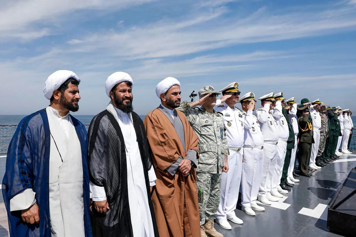 This handout photo made available by the Iranian Army Office on March 12, 2025, shows local officials and navy personnel attending a joint Iranian-Russian-Chinese military drill in the Gulf of Oman. The navies of Iran, Russia, and China were holding military drills off the coast of Iran that week in a bid to boost cooperation, according to Iranian media. (Iranian Army Office/AFP via Getty Images)