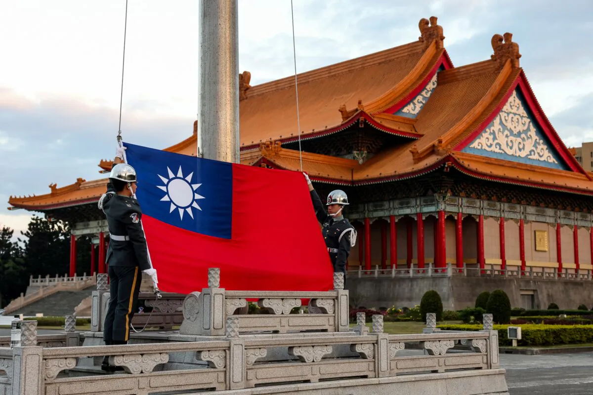 Guards raise Taiwan's national flag on the Democracy Boulevard at the Chiang Kai-shek Memorial Hall in Taipei, Tiawan, on Nov. 29, 2024. (I-Hwa Cheng AFP via Getty Images)