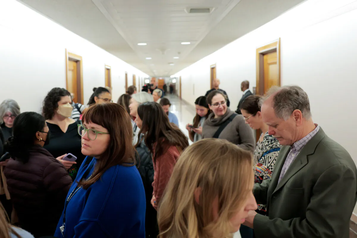 Recently laid off federal workers walk through the Dirksen Senate Office Building after meeting with staff members for Sen. Bill Cassidy (R-La.) in Washington on Feb. 25, 2025. (Anna Moneymaker/Getty Images)