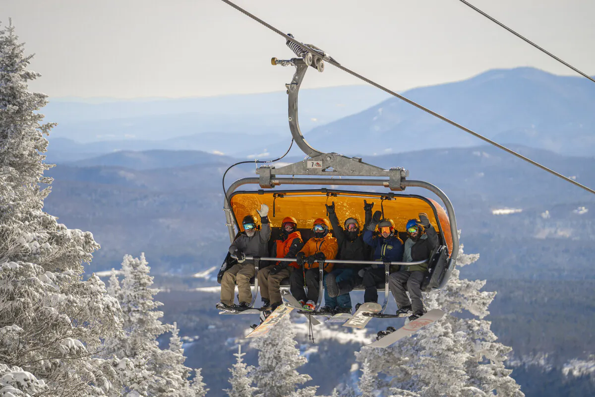On warmer days, snowboarders and skiers may choose not to use the weather-proof bubble on the chairlift heading to the top of Okemo Mountain Resort. (Corey Gambardella/Vail Resorts) 