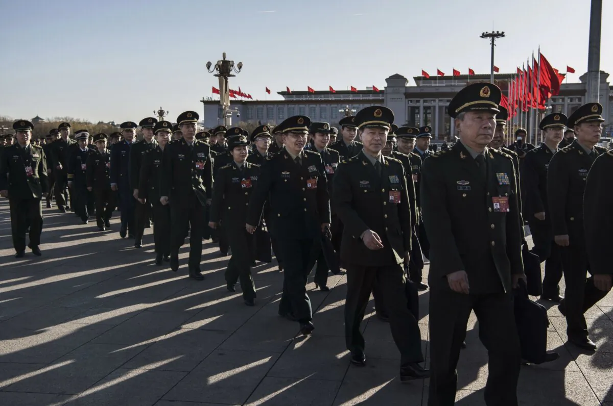Chinese military and police officers arrive for the third plenary session of the National People's Congress in Beijing on March 12, 2019. (Kevin Frayer/Getty Images)