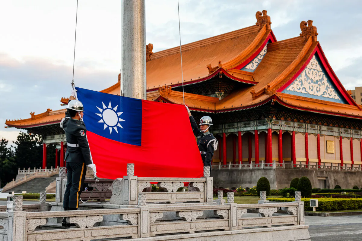 Guards raise Taiwan's national flag on the Democracy Boulevard at the Chiang Kai-shek Memorial Hall in Taipei on Nov. 29, 2024. (I-Hwa Cheng/AFP via Getty Images)