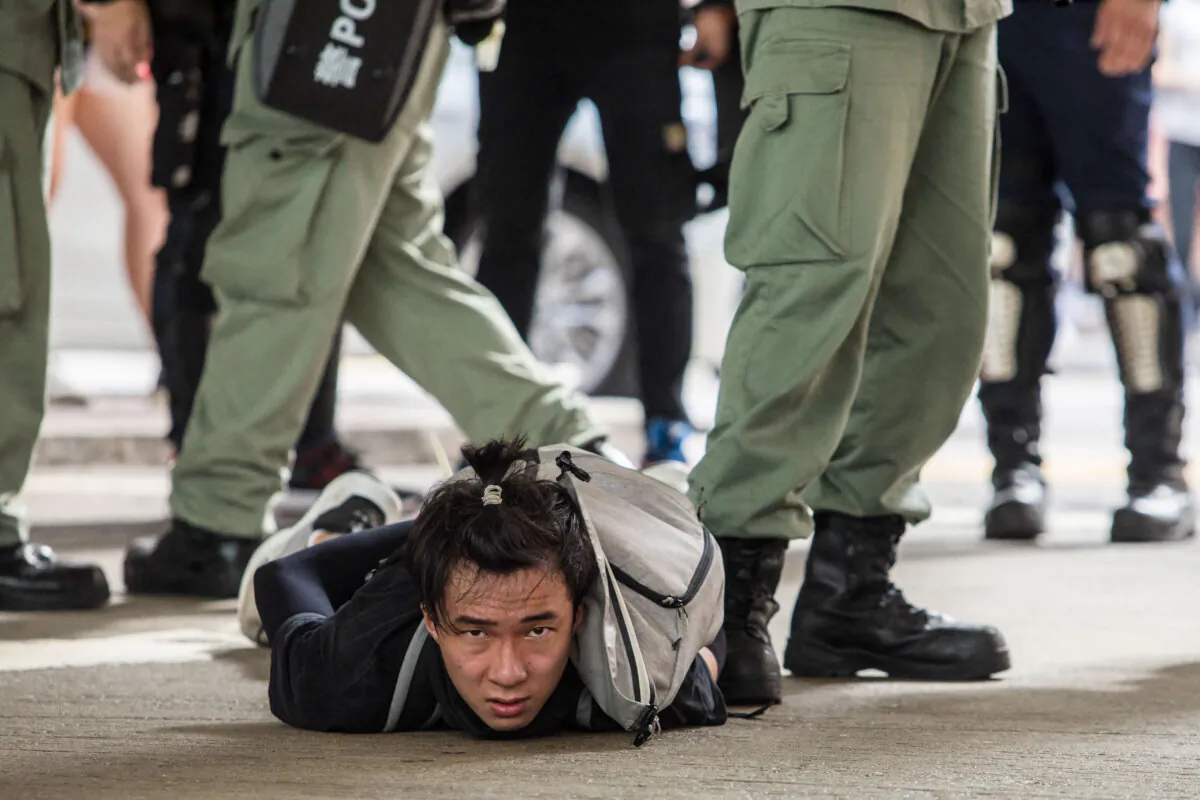 Riot police detain a man as they clear protesters taking part in a rally against a new national security law in Hong Kong on July 1, 2020, on the 23rd anniversary of the city's handover from Britain to China. (Dale De La Rey/AFP via Getty Images)