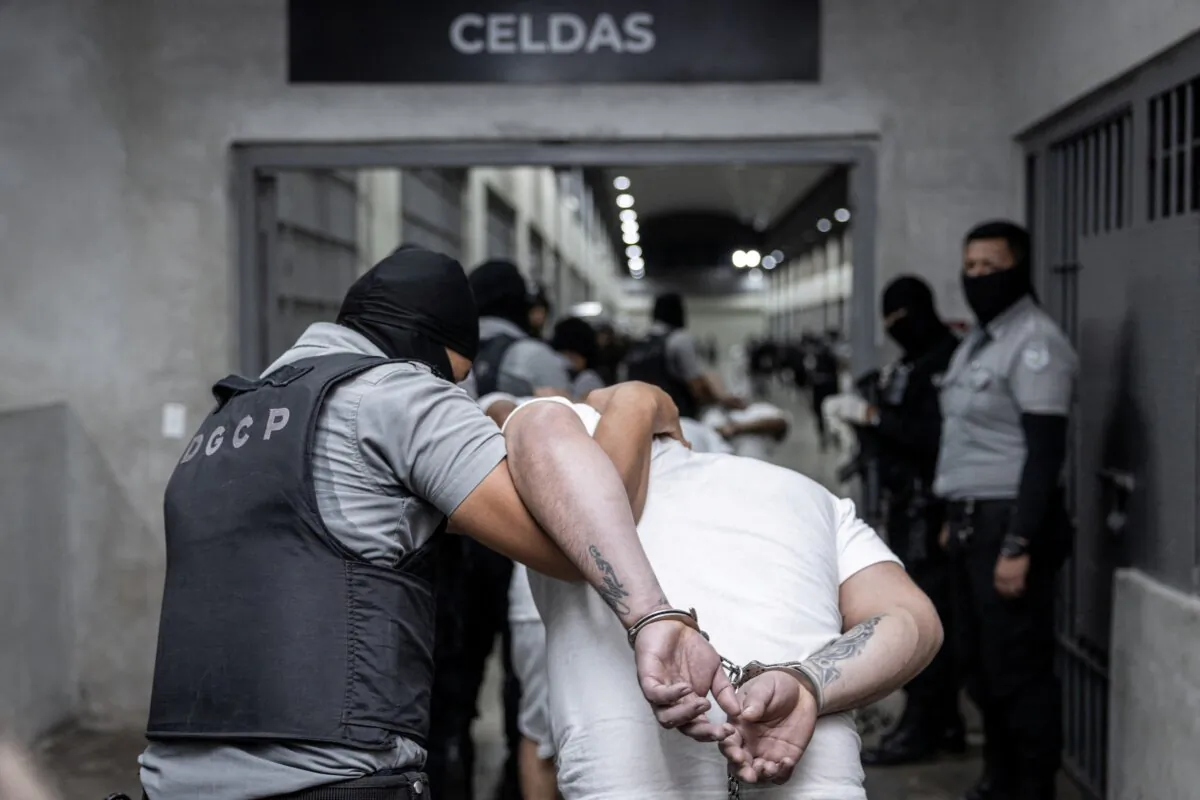 Salvadoran police officers escort alleged members of the Tren de Aragua gang recently deported by the U.S. government to be imprisoned in the Terrorism Confinement Center (CECOT) prison, as part of an agreement with the Salvadoran government, in Tecoluca, El Salvador, on March 16, 2025. (Secretaria de Prensa de la Presidencia/Handout via Reuters)