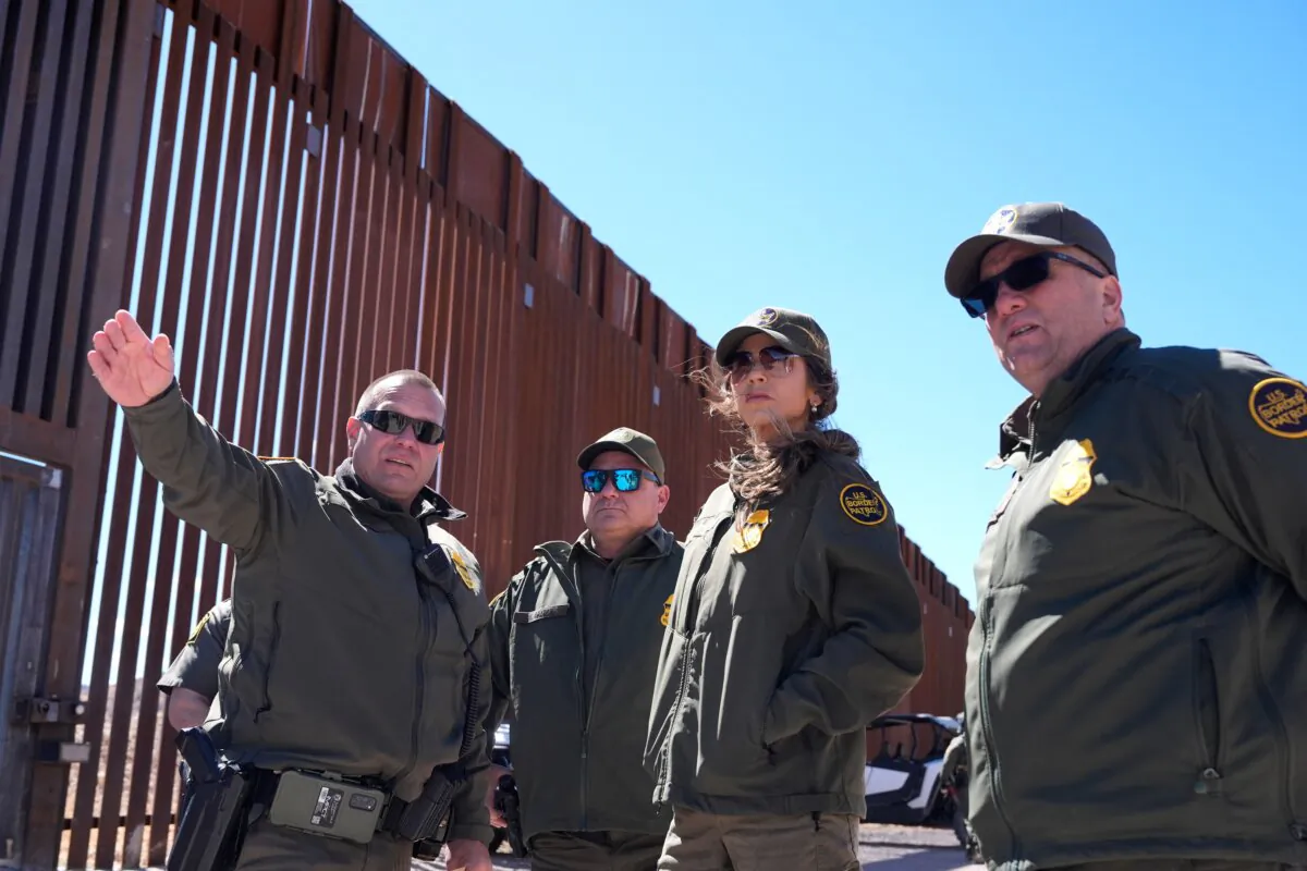 Secretary of Homeland Security Kristi Noem (2nd R) listens during a tour along the Nogales border wall at the Mariposa Port of Entry in Nogales, Ariz., on March 15, 2025. (Alex Brandon/Pool/AFP via Getty Images)