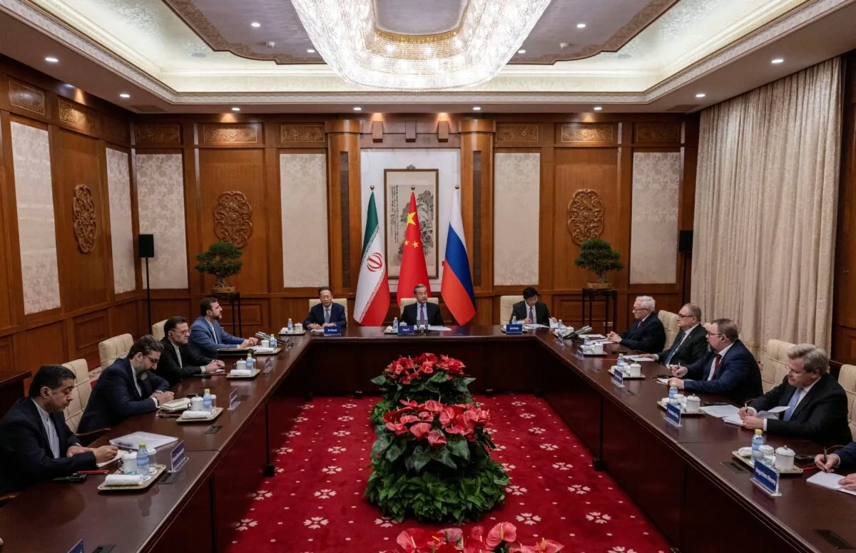 Wang Yi, Chinese foreign minister; Ryabkov Sergey Alexeevich, Russian deputy foreign minister; and Kazem Gharibabadi, Iranian deputy foreign minister, attend a meeting regarding the Iranian nuclear issue at Diaoyutai State Guest House in Beijing, on March 14, 2025. (Pool via Reuters)