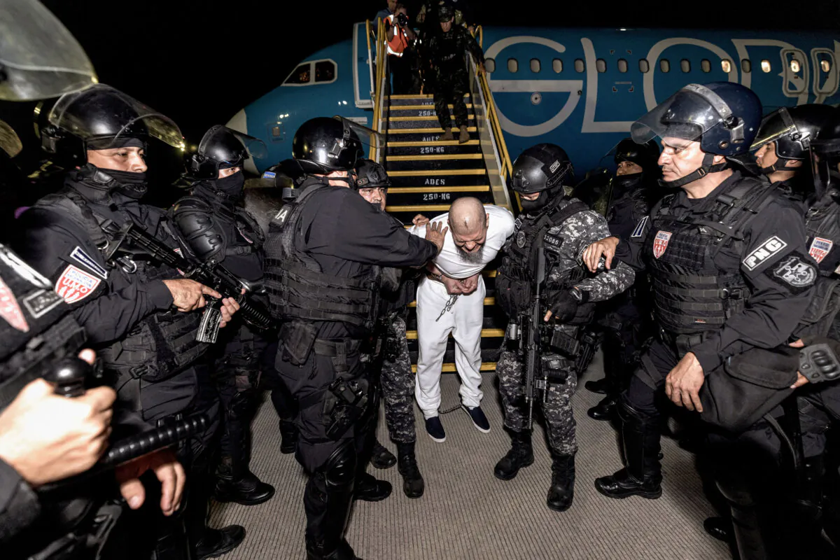 Salvadoran police escort alleged members of the Tren de Aragua, in San Luis Talpa, El Salvador. (Secretaria de Prensa de la Presidencia/Handout via Reuters)