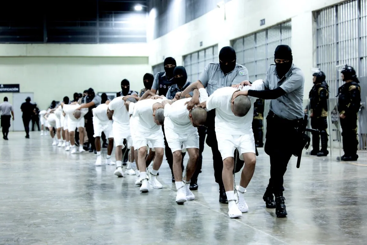 Police escort alleged members of Tren de Aragua deported by the U.S. government to be imprisoned in El Salvador as part of an agreement with the Salvadoran government, in Tecoluca, El Salvador, on March 16, 2025. (Secretaria de Prensa de la Presidencia/Handout via Reuters)