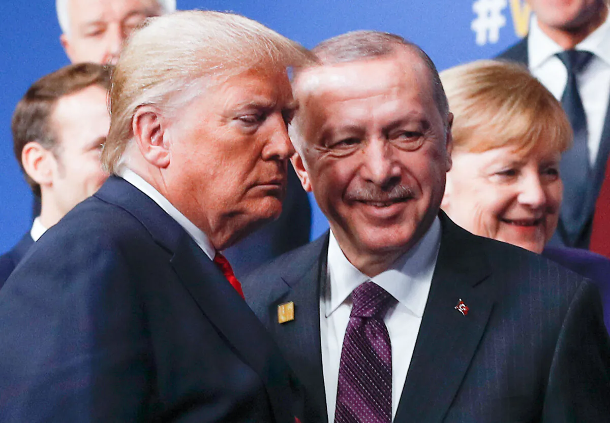 US President Donald Trump (L) and Turkey's President Recep Tayyip Erdogan (R) leave the stage after the family photo to head to the plenary session at the NATO summit at the Grove hotel in Watford, northeast of London on December 4, 2019. (Photo by PETER NICHOLLS / POOL / AFP) (Photo by PETER NICHOLLS/POOL/AFP via Getty Images)