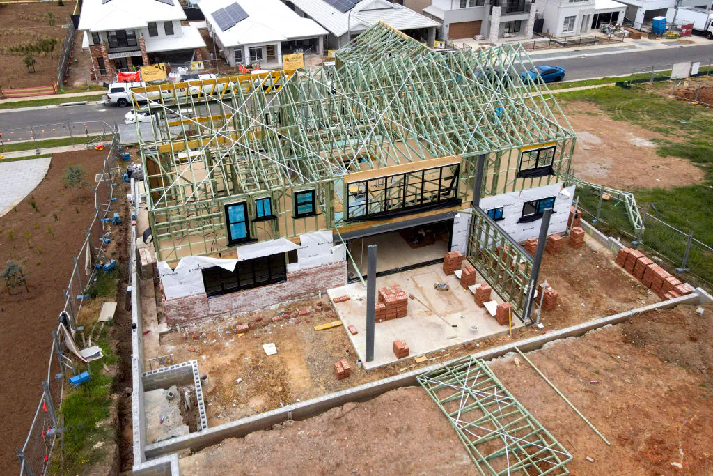 A house under construction stands in front of newly built homes at a housing development located in the south-west Sydney suburb of Menangle Park in Australia on Feb. 20, 2025. (David Gray/AFP via Getty Images)