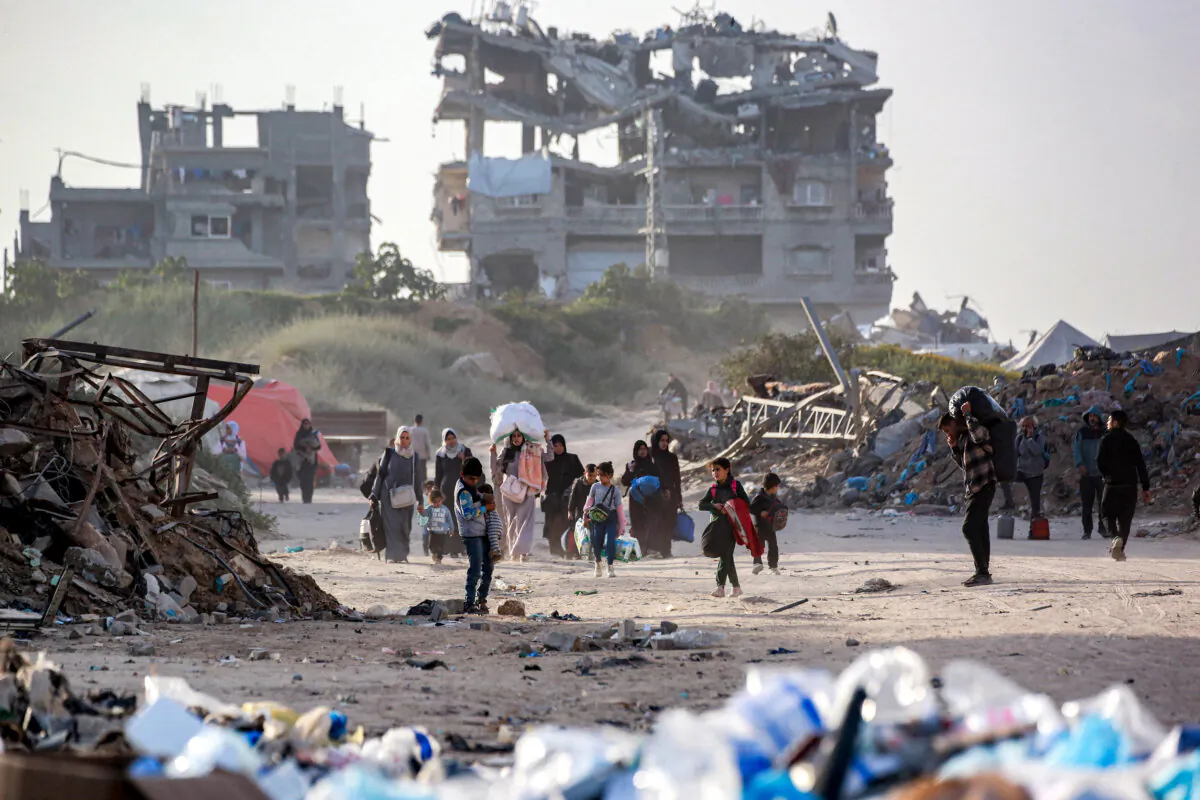 People displaced by the conflict between Israel and the Hamas terrorist group arrive carrying their belongings in Gaza City, on March 18, 2025. (Bashar Taleb/AFP via Getty Images)