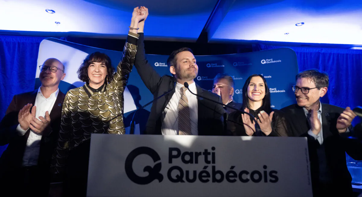 Parti Quebecois (PQ) candidate Catherine Gentilcore (2nd L) and party leader Paul St-Pierre Plamondon celebrate after winning the byelection in Terrebonne, Que., on March 17, 2025.   (The Canadian Press/Christinne Muschi)
